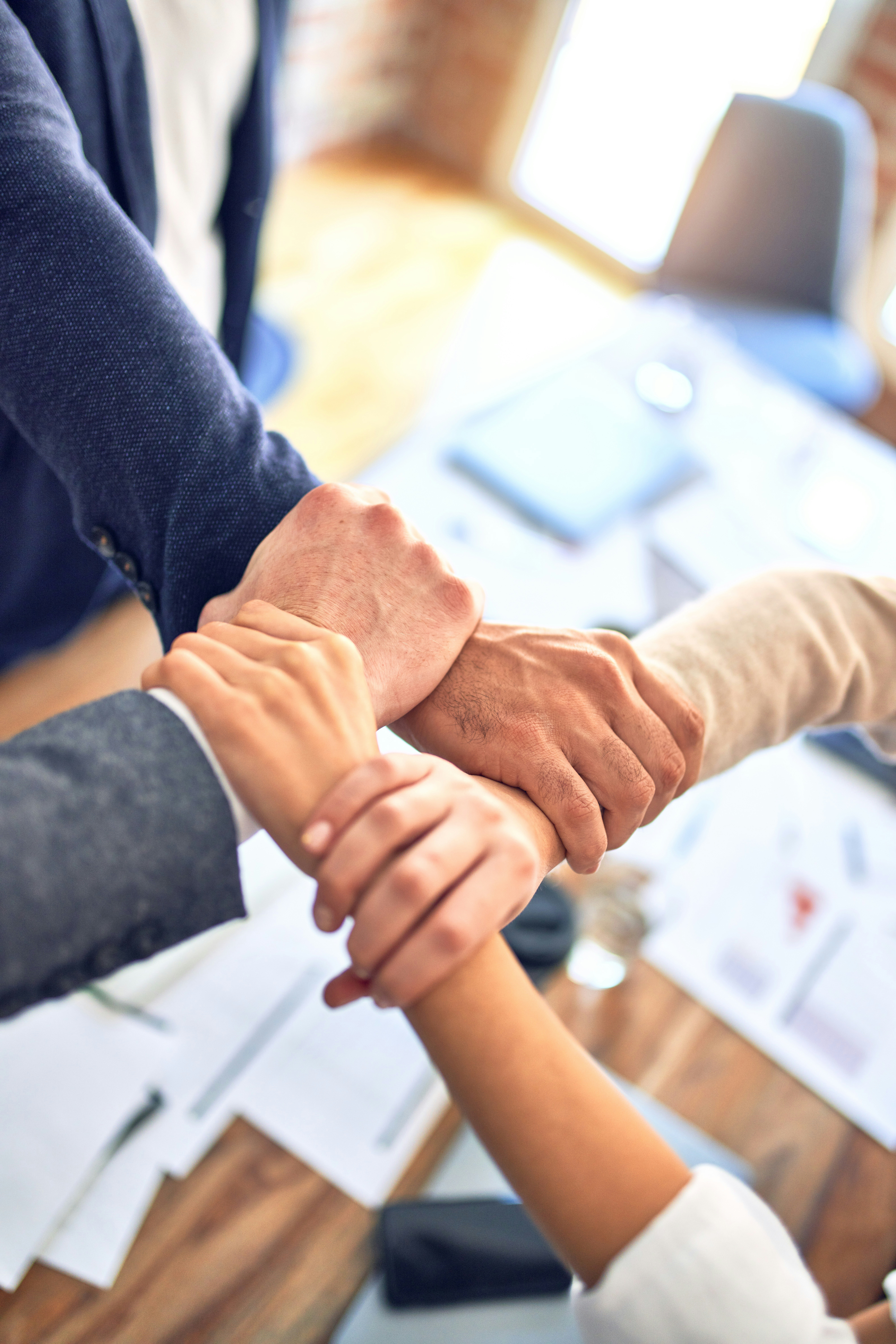 Team members shaking hands during successful AI project completion